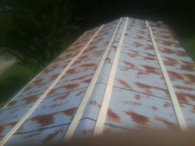 Rusted metal roof panels with new wood purlins before replacement — Storm Damage Roof Repair in Perryman by Roofing Brothers